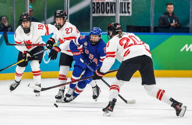 United States Kendall Coyne (26) moves the puck between Canada s Emma Maltais (27) and Canada s Sarah Nurse (20) and Canada s Brianne Jenner (19) in the first period of the Women s Hockey Gold Medal Game between Canada and the USA at the Milano Santagiulia Ice hockey, Eishockey Arena in Milan, Italy, on Thursday, February 19, 2026.  OLY20260219309 AARONxJOSEFCZYK