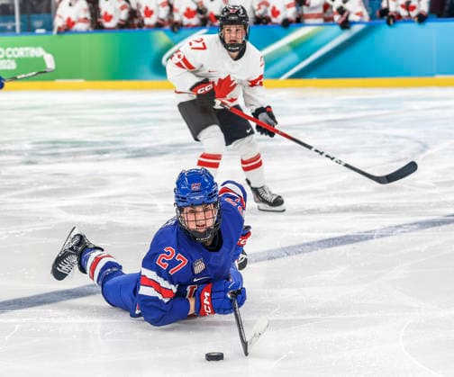 Canada s Emma Maltais (27) controls the puck on her stomach in front of Canada s Emma Maltais (27) in the second period of the Women s Hockey Gold Medal Game between Canada and the USA at the Milano Santagiulia Ice hockey, Eishockey Arena in Milan, Italy, on Thursday, February 19, 2026.  OLY20260219316 AARONxJOSEFCZYK