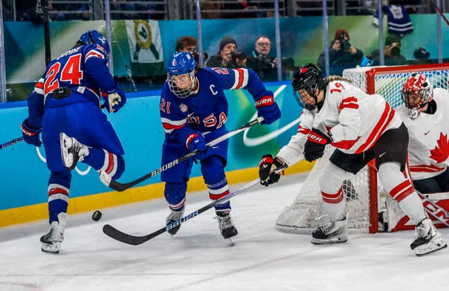United States Joy Dunne (24) steps over the puck as United States Hilary Knight (21) and Canada s Brianne Jenner (19) go for it in the second period of the Women s Hockey Gold Medal Game between Canada and the USA at the Milano Santagiulia Ice hockey, Eishockey Arena in Milan, Italy, on Thursday, February 19, 2026.  OLY20260219322 AARONxJOSEFCZYK