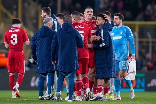 Nikola Milenkovic of Nottingham Forest Football Club, Murillo of Nottingham Forest Football Club, Morgan Gibbs-White of Nottingham Forest Football Club and the Nottingham Forest coaches embrace at full time Fenerbache v Nottingham Forest, UEFA Europa League, Knockout Round Play Offs, First Leg, Football, Sukru Saracoglu Stadium, Istanbul, Turkiye - 19 Feb 2026Istanbul Sukru Saracoglu Stadium Turkey EDITORIAL USE ONLY No use with unauthorised audio, video, data, fixture lists, club league logos or live services. Online in-match use limited to 120 images, no video emulation. No use in betting, games or single club league player publications. Copyright: xRaddadxJebarah Shutterstockx 16674269ed