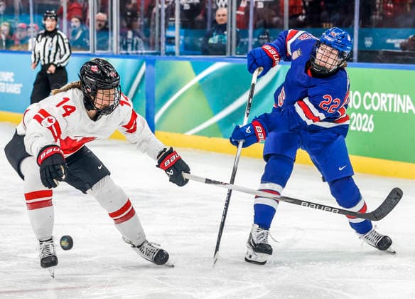 United States Tessa Janecke (22) passes the puck past Canada s Renata Fast (14) in the third period of the Women s Hockey Gold Medal Game between Canada and the USA at the Milano Santagiulia Ice hockey, Eishockey Arena in Milan, Italy, on Thursday, February 19, 2026.  OLY20260219326 AARONxJOSEFCZYK