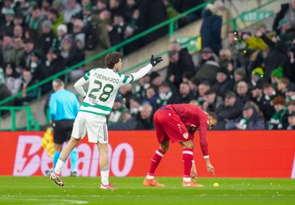 Sebastian Tounekti of Celtic removes balls thrown on to the pitch by Celtic fans as protest against the Celtic FC board. Celtic v Stuttgart, UEFA Europa League, Knockout Round Play Offs, First Leg, Football, Celtic Park, Glasgow, Scotland, UK - 19 Feb 2026Glasgow Celtic Park Scotland United Kingdom EDITORIAL USE ONLY No use with unauthorised audio, video, data, fixture lists, club league logos or live services. Online in-match use limited to 120 images, no video emulation. No use in betting, games or single club league player publications. Copyright: xStuartxWallace Shutterstockx 16674319r