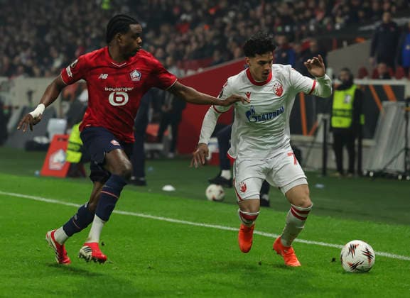 Lille v Crvena Zvezda, UEFA Europa League knock out play-offs 1st leg, season 2025 2026 Adem Avdic (R) of Crvena Zvezda in action against Nathan Ngoy of Lille during the UEFA Europa League 2025 26 League play-offs1st leg match between Lille and FK Crvena Zvezda at Stadium Pierre Mauroy on February 19, 2026 in Lille, France. Lille France Copyright: xPedjaxMilosavljevic STARSPORTx x