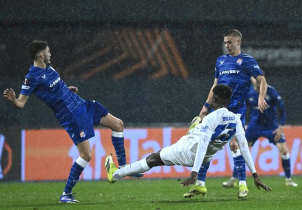 (260220) -- ZAGREB, Feb. 20, 2026 -- Fran Topic (L) and Luka Stojkovic (R) of GNK Dinamo vie with Aaron Bibout of KRC Genk during the UEFA Europa League 2025 26 Knockout Play-off First Leg match between GNK Dinamo and KRC Genk at Stadion Maksimir in Zagreb, Croatia, on Feb. 19, 2026. (Photo by PIXSELL via Xinhua) (SP)CROATIA-ZAGREB-FOOTBALL-UEFA-GNK DINAMO VS KRC GENK MarkoxLukunic 