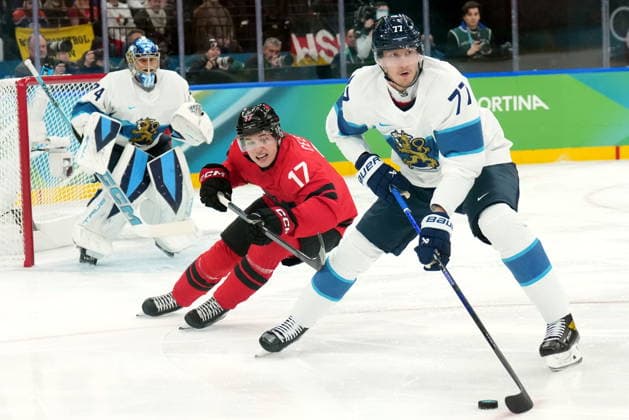 February 20, 2026, Milan, Italy: NIKO MIKKOLA of Finland keeping puck away from Macklin Celebrini of Canada during first period of men s semifinal hockey game at the 2026 Milano Cortina Olympics. Olympics 2026: Milano Cortina: Ice hockey, Eishockey Men s Semifinal CAN:FIN  - ZUMAc35_ 20260220_zaf_c35_037 Copyright: xNathanxDenettex