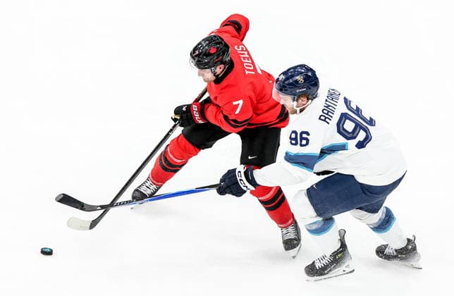 ITALY, MILAN - FEBRUARY 20, 2026: Canada s Devon Toews (L) and Finland s Mikko Rantanen fight for the puck in a menâ€™s Ice hockey, Eishockey play-off semifinal match at the Milano Santagiulia Ice Hockey Arena, as part of the 2026 Winter Olympic Games, Olympische Spiele, Olympia, OS Peter Kovalev TASS  89000956