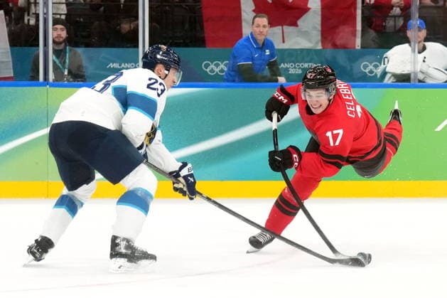 February 20, 2026, Milan, ITALY: Canada forward Macklin Celebrini (17) shoots the puck past Finland defenceman Esa Lindell (23) during first period Men s Olympic semifinal Ice hockey, Eishockey action at the 2026 Milan Cortina Winter Olympics in Milan, Friday, Feb. 20, 2026. Canada News - February 20, 2026  - ZUMAc35_ 20260220_zaf_c35_047 Copyright: xNathanxDenettex