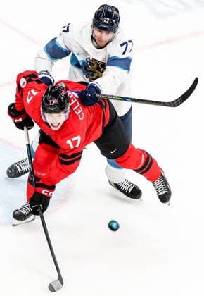 ITALY, MILAN - FEBRUARY 20, 2026: Canada s Macklin Celebrini (front) and Finland s Niko Mikkola fight for the puck in a menâ€™s Ice hockey, Eishockey play-off semifinal match at the Milano Santagiulia Ice Hockey Arena, as part of the 2026 Winter Olympic Games, Olympische Spiele, Olympia, OS Peter Kovalev TASS  89000953