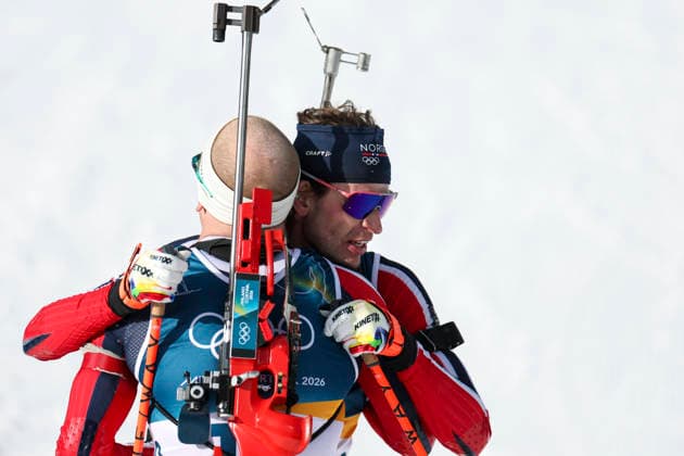 (260220) -- ANTERSELVA, Feb. 20, 2026 -- Johannes Dale-Skjevdal (L) of Norway hugs his teammate Sturla Holm Laegreid after the biathlon men s 15km mass start event at the 2026 Milan-Cortina Winter Olympics in Anterselva, Italy, Feb. 20, 2026. ) (MICO2026)ITALY-ANTERSELVA-OLYMPIC Winter games, Winterspiele,Spiele, Summer games BIATHLON-MEN S 15KM MASS START ZhangxTao 