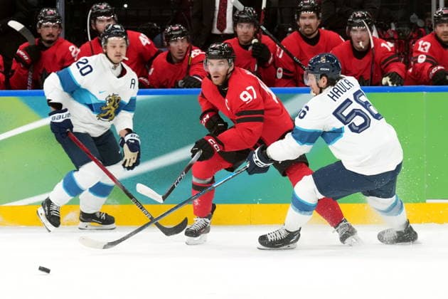 February 20, 2026, Milan, ITALY: Canada forward Connor McDavid (97) moves the puck between Finland forward Sebastian Aho (20) and teammate Erik Haula (56) during second period Men s Olympic semifinal Ice hockey, Eishockey action at the 2026 Milan Cortina Winter Olympics in Milan, Friday, Feb. 20, 2026. Canada News - February 20, 2026  - ZUMAc35_ 20260220_zaf_c35_050 Copyright: xNathanxDenettex