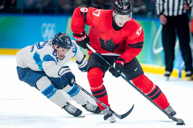 OLYMPICS - Winter Olympic Games, Olympische Spiele, Olympia, OS Milano Cortina 2026 MILAN,ITALY,20.FEB.26 - OLYMPICS, Ice hockey, Eishockey - Winter Olympic Games Milano Cortina 2026, semifinal, Canada vs Finland, men. Image shows Artturi Lehkonen (FIN) and Macklin Celebrini (CAN).  GEPAxpictures xMatthiasxTrinkl