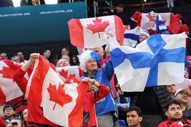 February 20, 2026, Milan, Lombardy, Italy: Team Finland fan among flags of Team Canada in a men s Ice hockey, Eishockey semifinal during the Milano Cortina 2026 Olympic Winter games, Winterspiele,Spiele, Summer games at Milano Santagiulia Ice Hockey Arena Milan Italy - ZUMAm117 20260220_oly_m117_018 Copyright: xDavidxMcIntyrex