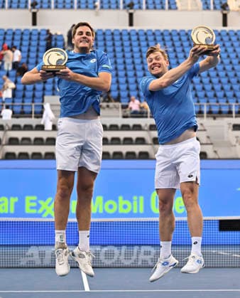 February 20, 2026, Doha, Qatar: Harri Heliovaara of Finland and Henry Patten of Great Britain pose with their trophies after winning their men™s Doubles Final match against Julian Cash and Lloyd Glasspool of Great Britain (not in view) during the ATP, Tennis Herren Qatar ExxonMobil Open 2026 tennis tournament at the Khalifa International Tennis Complex. Harri Heliovaara Henry Patten won against Julian Cash and Lloyd Glasspool 6-3.6-3. ATP Qatar Exxonmobil Open 2026 Tennis Tournament In Doha - 20 Feb 2026  - ZUMAs197 20260220_aaa_s197_052 Copyright: xNoushadxVariyattiyakkalx