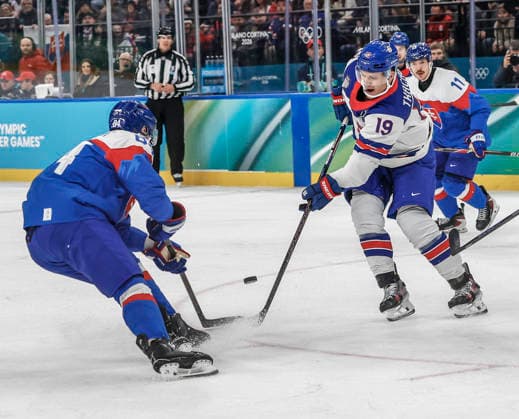 United States Matthew Tkachuk (19) and Slovakia s Pavol Regenda (84) battle for the puck in the first period of the Men s Hockey Play-off Semifinal game between Slovakia and the USA at the Milano Santagiulia Ice hockey, Eishockey Arena in Milan, Italy, on Friday, February 20, 2026.  OLY20260220312 AARONxJOSEFCZYK
