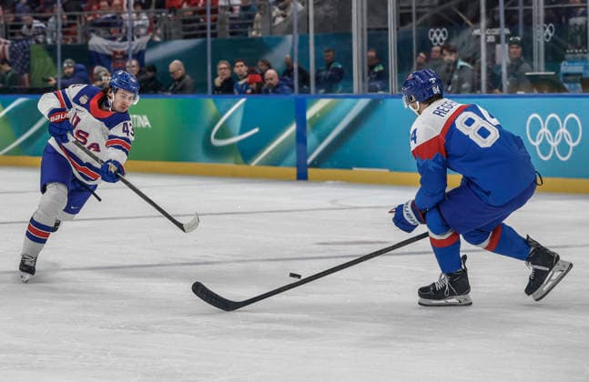 United States Quinn Hughes (43) takes a shot past Slovakia s Pavol Regenda (84) in the first period of the Men s Hockey Play-off Semifinal game between Slovakia and the USA at the Milano Santagiulia Ice hockey, Eishockey Arena in Milan, Italy, on Friday, February 20, 2026.  OLY20260220313 AARONxJOSEFCZYK