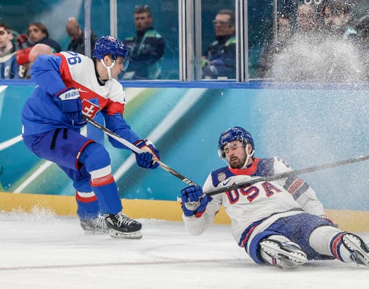 United States Dylan Larkin (21) falls in front of Slovakia s Martin Pospisil (76) in the first period of the Men s Hockey Play-off Semifinal game between Slovakia and the USA at the Milano Santagiulia Ice hockey, Eishockey Arena in Milan, Italy, on Friday, February 20, 2026.  OLY20260220314 AARONxJOSEFCZYK