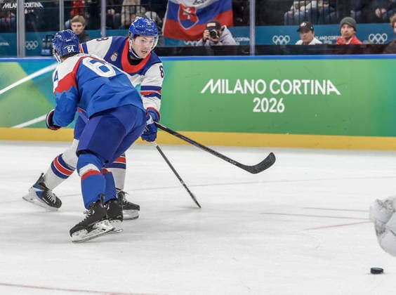 United States Zach Werenski (8) takes a shot on Slovakia s Patrik Koch (64) in the first period of the Men s Hockey Play-off Semifinal game between Slovakia and the USA at the Milano Santagiulia Ice hockey, Eishockey Arena in Milan, Italy, on Friday, February 20, 2026.  OLY20260220316 AARONxJOSEFCZYK