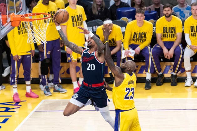 February 20, 2026, Los Angeles, California, USA: Los Angeles Clippers John Collins (20) goes past Los Angeles LakersÃ¢â‚¬â ¢ LeBron James (23) to the basket during an NBA, Basketball Herren, USA basketball game at Crypto.com Arena on Friday, Feb. 20, 2026 in Los Angeles. Los Angeles USA - ZUMAc68_ 20260220_zaf_c68_002 Copyright: xRingoxChiux