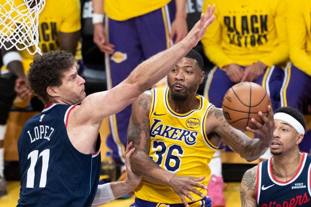 February 20, 2026, Los Angeles, California, USA: Los Angeles LakersÃ¢â‚¬â ¢ Marcus Smart (36) goes to the basket under pressure from Los Angeles Clippers Brook Lopez (11) during an NBA, Basketball Herren, USA basketball game at Crypto.com Arena on Friday, Feb. 20, 2026 in Los Angeles. Los Angeles USA - ZUMAc68_ 20260220_zaf_c68_066 Copyright: xRingoxChiux