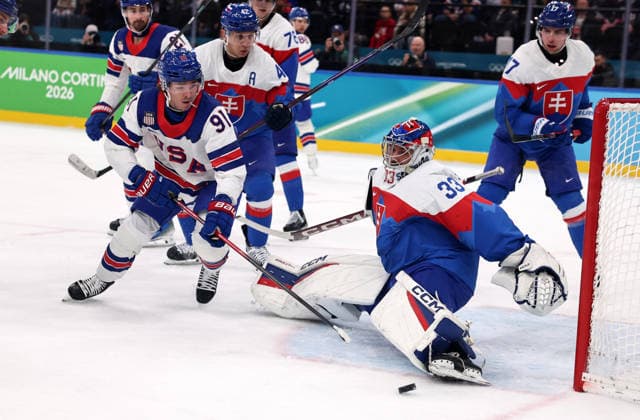 (260221) -- MILAN, Feb. 21, 2026 -- Stanislav Skorvanek (2nd R), goalkeeper of Slovakia makes a save during the Ice hockey, Eishockey men s play-offs semifinal match between the United States and Slovakia at the Milan-Cortina 2026 Olympic Winter games, Winterspiele,Spiele, Summer games in Milan, Italy, Feb. 20, 2026. ) (MICO2026)ITALY-MILAN-OLYMPIC WINTER GAMES-ICE HOCKEY-MEN-PLAY-OFFS SEMIFINALS-USA VS SVK WangxKaiyan 