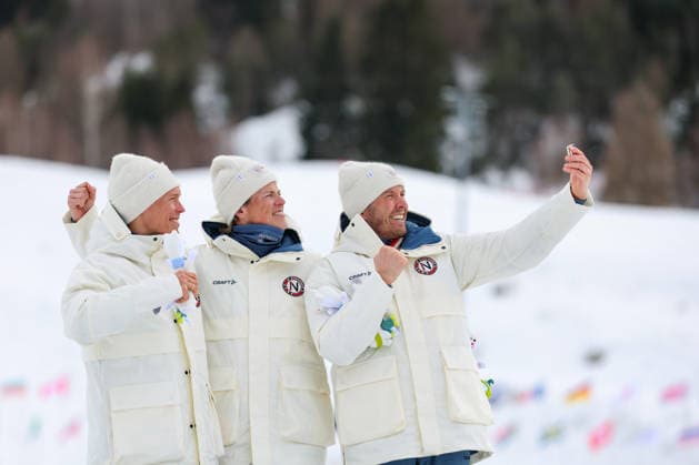 (260221) -- TESERO, Feb. 21, 2026 -- Gold medalist Johannes Hoesflot Klaebo (C) of Norway, silver medalist Martin Loewstroem Nyenget (L) of Norway and bronze medalist Emil Iversen of Norway take selfies on the podium after the cross-country skiing men s 50km mass start classic event at the Milan-Cortina 2026 Olympic Winter games, Winterspiele,Spiele, Summer games in Tesero, Italy, Feb. 21, 2026. ) (MICO2026)ITALY-TESERO-OLYMPIC WINTER GAMES-CROSS-COUNTRY SKIING-MEN S 50KM MASS START-CLASSIC HuangxWei 