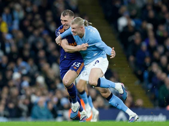 Manchester, England, 21st February 2026. Dan Burn of Newcastle United tussles with Erling Haaland of Manchester City during the Manchester City vs Newcastle United Premier League match at the Etihad Stadium, Manchester. Picture credit should read: Cody Froggatt Sportimage EDITORIAL USE ONLY. No use with unauthorised audio, video, data, fixture lists, club league logos or live services. Online in-match use limited to 120 images, no video emulation. No use in betting, games or single club league player publications. SPI_018_CF_Man_City_Newc SPI-4542-0018