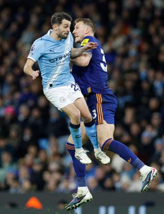 Manchester, England, 21st February 2026. Bernardo Silva of Manchester City challenges Dan Burn of Newcastle United during the Manchester City vs Newcastle United Premier League match at the Etihad Stadium, Manchester. Picture credit should read: Cody Froggatt Sportimage EDITORIAL USE ONLY. No use with unauthorised audio, video, data, fixture lists, club league logos or live services. Online in-match use limited to 120 images, no video emulation. No use in betting, games or single club league player publications. SPI_054_CF_Man_City_Newc SPI-4542-0055