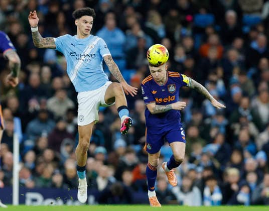 Manchester, England, 21st February 2026. Nico O™Reilly of Manchester City tussles with Kieran Trippier of Newcastle United during the Manchester City vs Newcastle United Premier League match at the Etihad Stadium, Manchester. Picture credit should read: Cody Froggatt Sportimage EDITORIAL USE ONLY. No use with unauthorised audio, video, data, fixture lists, club league logos or live services. Online in-match use limited to 120 images, no video emulation. No use in betting, games or single club league player publications. SPI_058_CF_Man_City_Newc SPI-4542-0058