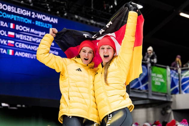 CORTINA, ITALY - FEBRUARY 21: Lisa Buckwitz Neele Schuten (Germany) cheer with a flag during the Bobsleigh 2-woman Heat 3 and 4 at the Milano Cortina 2026 Olympics at Cortina Sliding Centre on day 15 of the Milano Cortina 2026 Olympics on February 21, 2026 in Cortina, Italy. Editorial use only. Italy Copyright: xSteffiexWunderlx