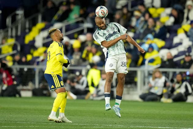 February 21, 2026, Nashville, Tennessee, USA: New England Revolution defender Andrew Farrell (88) heads the ball against Nashville SC midfielder Hany Mukhtar (10) during the second half at Geodis Park. Nashville USA - ZUMAh237 20260221_zsp_h237_085 Copyright: xCamdenxHallx
