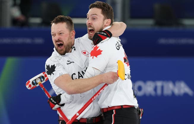 (260222) -- CORTINA D AMPEZZO, Feb. 22, 2026 -- Ben Hebert (L) of Canada and Brett Gallant of Canada celebrate after the curling men s gold medal game between Canada and Britain at the 2026 Milan-Cortina Winter Olympics in Cortina, Italy, Feb. 21, 2026. ) (MICO2026)ITALY-CORTINA D AMPEZZO-OLYMPIC Winter games, Winterspiele,Spiele, Summer games CURLING-MEN-GOLD MEDAL GAME-CAN VS GBR ZhangxChenlin 