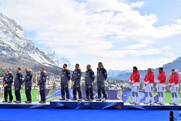 Cortina d Ampezzo, Italy, February 22th 2026. First place and Gold medal Johannes Lochner, Thorsten Margis, Jorn Wenzel, Georg Fleischhauer of Germany, Second place and Silver medal Francesco Friedrich, Matthias Sommer, Alexander Schuller, Felix Straub of Germany and Third place and Bronze medal Michael Vogt, Andreas Haas, Amadou David Ndiaye, Aeberhard of Switzwerland celebrate in podium after the Bobsleight 4-man Heat 4 race of the Olympic Winter games, Winterspiele,Spiele, Summer games 2026 in Cortina d Ampezzo, Italy. (Photo by Igor Kupljenik Sports Press Photo)  Copyright: xIgorxKupljenikx xSPPx Sportspressphoto_SPR96163