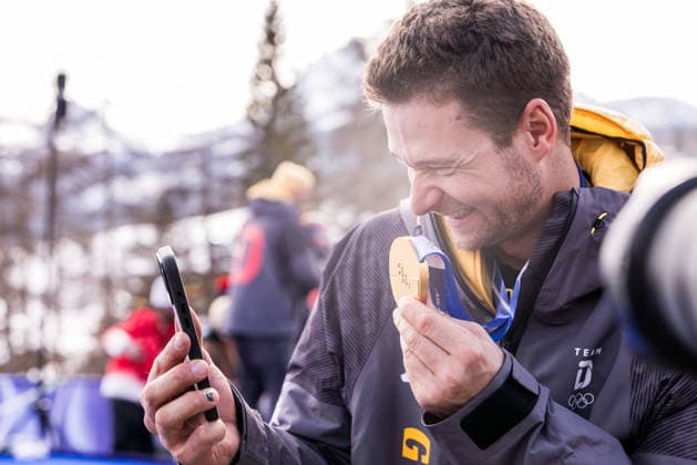 CORTINA, ITALY - FEBRUARY 22: Gold medalist Johannes Lochner (Germany) calling his wife to show her the Gold medal of the final race of his career during the Bobsleigh 4-man medal ceremony at the Milano Cortina 2026 Olympics at Cortina Sliding Centre on day 16 of the Milano Cortina 2026 Olympics on February 22, 2026 in Cortina, Italy. Editorial use only. Italy Copyright: xSteffiexWunderlx