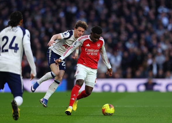 22nd February 2026; Tottenham Hotspur Stadium, London, England; Premier League Football, Tottenham Hotspur versus Arsenal; Bukayo Saka of Arsenal under pressure from Conor Gallagher of Tottenham Hotspur  JPxFletcher Content restricted for UK based newspaper