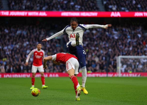 22nd February 2026; Tottenham Hotspur Stadium, London, England; Premier League Football, Tottenham Hotspur versus Arsenal; Djed Spence of Tottenham Hotspur challenges Leandro Trossard of Arsenal  JPxFletcher Content restricted for UK based newspaper