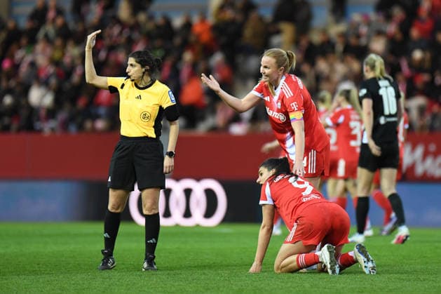 Glodis Viggosdottir 4 FC Bayern helps Jovana Damnjanovic, who is lying on the ground 9 Bayern at the Google Pixel Womens Bundesliga match FC Bayern Munich Vfl Wolfsburg on 22 02 2026 Munich FC Bayern Campus Bayern Germany