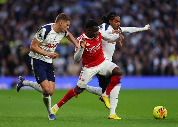 22nd February 2026; Tottenham Hotspur Stadium, London, England; Premier League Football, Tottenham Hotspur versus Arsenal; Bukayo Saka of Arsenal under pressure from Djed Spence and Micky van de Ven of Tottenham Hotspur  JPxFletcher Content restricted for UK based newspaper