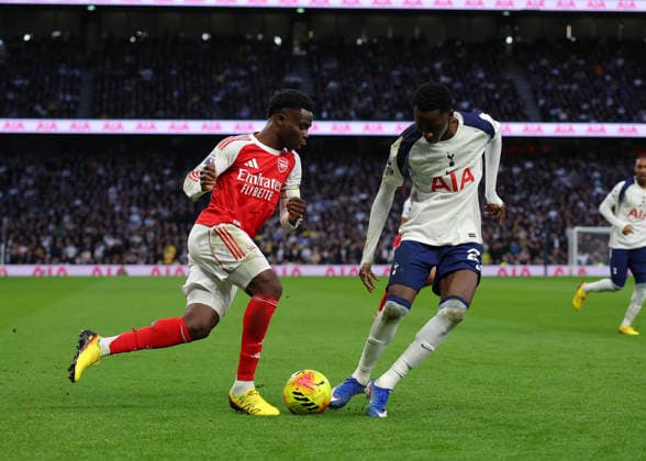 22nd February 2026; Tottenham Hotspur Stadium, London, England; Premier League Football, Tottenham Hotspur versus Arsenal; Pape Matar Sarr of Tottenham Hotspur loses the ball to Bukayo Saka of Arsenal  JPxFletcher Content restricted for UK based newspaper