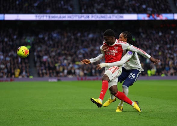 22nd February 2026; Tottenham Hotspur Stadium, London, England; Premier League Football, Tottenham Hotspur versus Arsenal; Bukayo Saka of Arsenal under pressure from Djed Spence of Tottenham Hotspur  JPxFletcher Content restricted for UK based newspaper