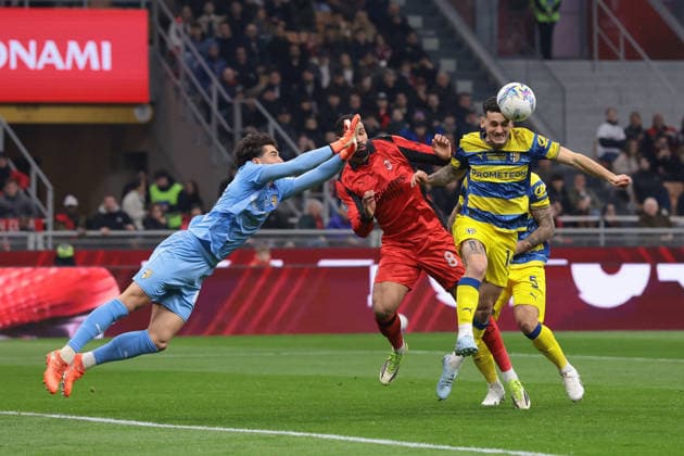 Milan, Italy, 22nd February 2026. Edoardo Corvi of Parma Calcio clahses with Ruben Loftus-Cheek of AC Milan as Emanuele Valeri of Parma Calcio heads the ball clear during the AC Milan vs Parma Serie A match at Giuseppe Meazza, Milan. Picture credit should read: Jonathan Moscrop Sportimage EDITORIAL USE ONLY. No use with unauthorised audio, video, data, fixture lists, club league logos or live services. Online in-match use limited to 120 images, no video emulation. No use in betting, games or single club league player publications. SPI_001_MILAN_PARMA SPI-4549-0001