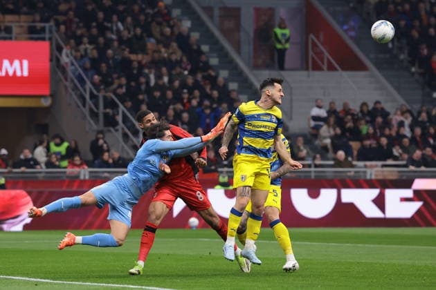 Milan, Italy, 22nd February 2026. Edoardo Corvi of Parma Calcio clahses with Ruben Loftus-Cheek of AC Milan as Emanuele Valeri of Parma Calcio heads the ball clear during the AC Milan vs Parma Serie A match at Giuseppe Meazza, Milan. Picture credit should read: Jonathan Moscrop Sportimage EDITORIAL USE ONLY. No use with unauthorised audio, video, data, fixture lists, club league logos or live services. Online in-match use limited to 120 images, no video emulation. No use in betting, games or single club league player publications. SPI_003_MILAN_PARMA SPI-4549-0003