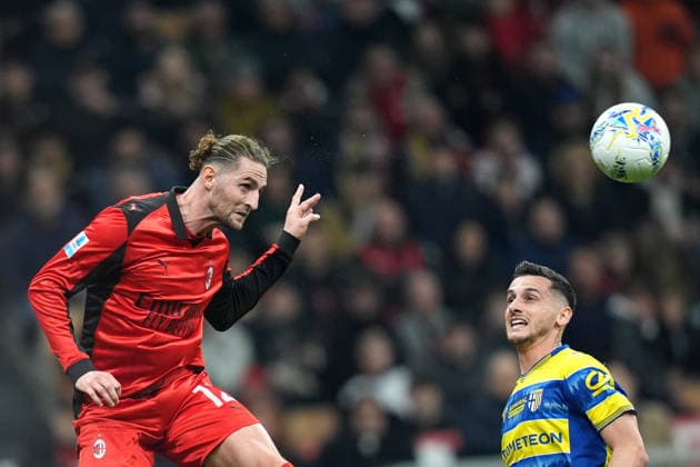 AC Milan s Adrien Rabiot fights for the bass with Parma™s Emanuele Valeri during the Serie A soccer match between Ac Milan and Parma at the San Siro Stadium in Milan , north Italy - Sunday , February 22 , 2025. - Soccer .  Copyright: xSpada LaPressex