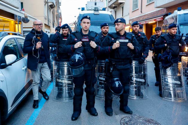 Italian Carabinieri look on as people demonstrate before the Closing Ceremony of the Milano Cortina 2026 Olympic Games, Olympische Spiele, Olympia, OS outside the Verona Arena in Verona, Italy on Sunday, February 22, 2026. Norway won the most medals with a total of 41, with the United States following at 33.  ITA20260222804 AARONxJOSEFCZYK