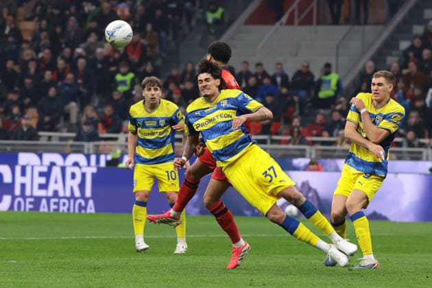 Milan, Italy, 22nd February 2026. Mariano Troilo of Parma Calcio heads clear from Koni De Winter of AC Milan during the AC Milan vs Parma Serie A match at Giuseppe Meazza, Milan. Picture credit should read: Jonathan Moscrop Sportimage EDITORIAL USE ONLY. No use with unauthorised audio, video, data, fixture lists, club league logos or live services. Online in-match use limited to 120 images, no video emulation. No use in betting, games or single club league player publications. SPI_082_MILAN_PARMA SPI-4549-0082