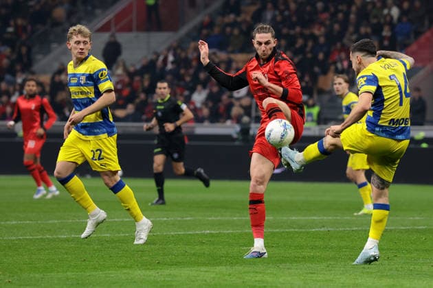 Milan, Italy, 22nd February 2026. Oliver Jensen of Parma Calcio looks on as team mate Emanuele Valeri clears the ball from Adrien Rabiot of AC Milan during the AC Milan vs Parma Serie A match at Giuseppe Meazza, Milan. Picture credit should read: Jonathan Moscrop Sportimage EDITORIAL USE ONLY. No use with unauthorised audio, video, data, fixture lists, club league logos or live services. Online in-match use limited to 120 images, no video emulation. No use in betting, games or single club league player publications. SPI_090_MILAN_PARMA SPI-4549-0090