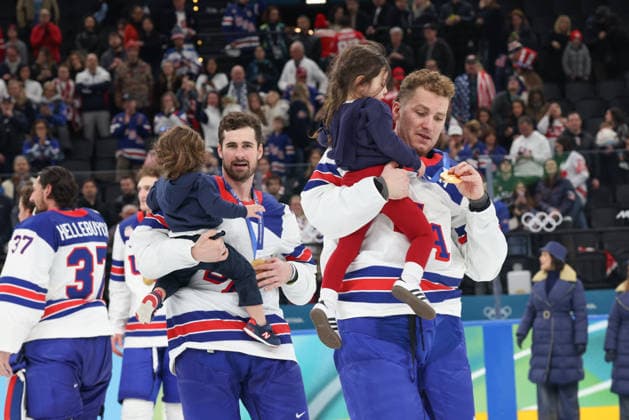 February 22, 2026: Teammates Zach Werenski (8) Dylan Larkin (21) of the United States carry the children of Johnny Gaudreau and his number 13 jersey after winning the Gold medal in the Mens Ice hockey, Eishockey Gold Medal game between Canada and USA held at Milano Santagiulia Ice Hockey Arena during the Milano Cortina 2026 Olympic Games, Olympische Spiele, Olympia, OS in Milan, Italy. MilanoCortina2026 Olympics Milano Cortina 2026: Gold Medal Game Mens Ice Hockey Canada Vs United States Feb 22  - ZUMAc04_ 20260222_zma_c04_101 Copyright: xDanielxLeax