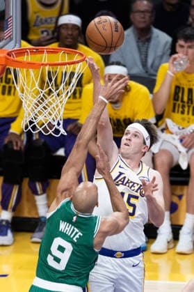 February 22, 2026, Los Angeles, California, United States: Los Angeles Lakers™ Austin Reaves (15) shoots against Boston Celtics™ Derrick White (9) during an NBA, Basketball Herren, USA basketball game at Crypto.com Arena on Sunday, Feb. 22, 2026 in Los Angeles. Los Angeles United States - ZUMAs197 20260222_aaa_s197_316 Copyright: xRingoxChiux