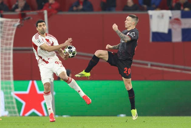 Mehdi Taremi Olympiacos FC and Alejandro Grimaldo Bayer 04 Leverkusen battle for the ball during the UEFA Champions League 2025 26 League Knockout Play off Second Leg match between Bayer 04 Leverkusen and Olympiacos FC at BayArena on February 24, 2026 in Leverkusen, Germany Photo by Oliver Kaelke DeFodi Images