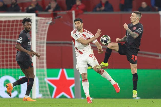 Mehdi Taremi Olympiacos FC and Alejandro Grimaldo Bayer 04 Leverkusen battle for the ball during the UEFA Champions League 2025 26 League Knockout Play off Second Leg match between Bayer 04 Leverkusen and Olympiacos FC at BayArena on February 24, 2026 in Leverkusen, Germany Photo by Oliver Kaelke DeFodi Images
