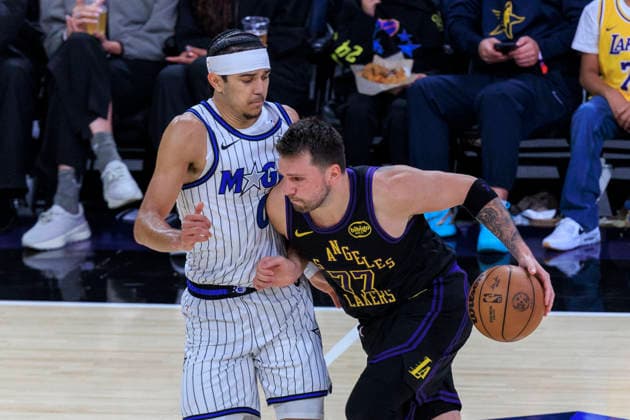 February 24, 2026, Los Angeles, California, USA: Luka Doncic 77 of the Los Angeles Lakers drives as Anthony Black 0 of the Orlando Magic guards during their regular season NBA, Basketball Herren, USA game on Tuesday February 24, 2026 at Crypto.com Arena in Los Angeles, California. Lakers lose to Magic, 109-110. ARIANA RUIZ PI Lakers Vs. Magic  - ZUMAp124 20260224_zaa_p124_026 Copyright: xArianaxRuizx